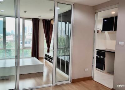 Interior view featuring a bedroom, a hallway, and a kitchen