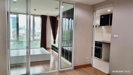 Interior view featuring a bedroom, a hallway, and a kitchen