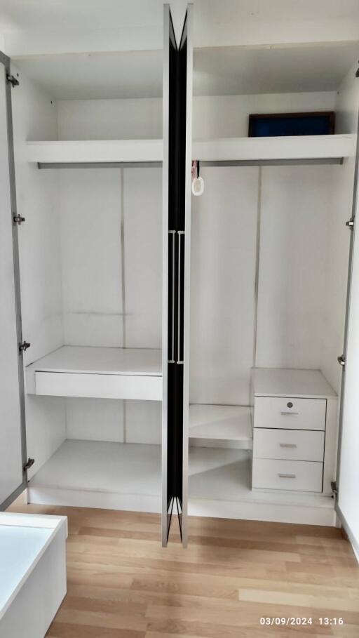 Open closet with shelving and drawers