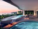 Luxurious outdoor lounge area with pools and ocean view at sunset