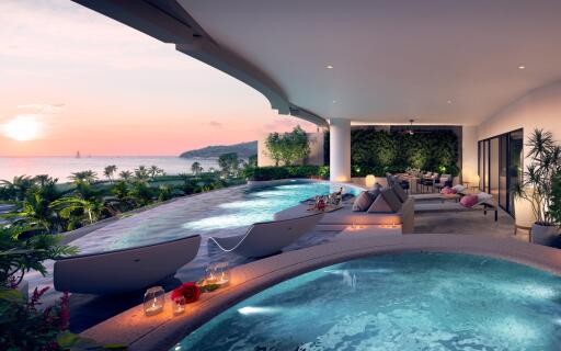 Luxurious outdoor lounge area with pools and ocean view at sunset