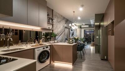 Modern kitchen with island, washing machine, stove, and dining area