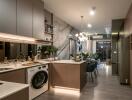 Modern kitchen with island, washing machine, stove, and dining area