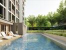 Outdoor pool area with lounge chairs and greenery