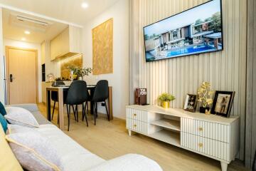 Modern living room with wall-mounted TV and dining area