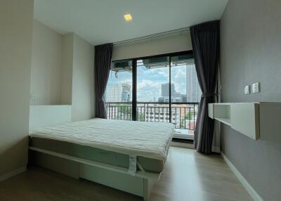 Modern bedroom with large window and city view