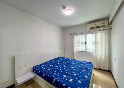 Bedroom with a blue, star-patterned bedspread