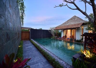 Beautiful view of outdoor pool area with a traditional-style house and garden