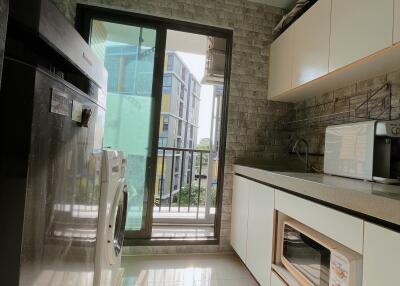 Modern kitchen with appliances and balcony view