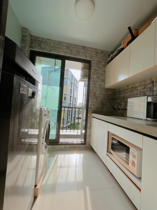 Modern kitchen with appliances and balcony view