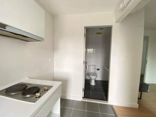 small kitchen with view into bathroom