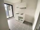 Modern compact kitchen with white cabinetry and stainless steel sink