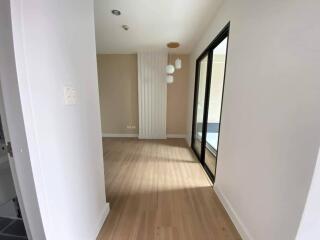 Modern living space with wooden flooring and large windows