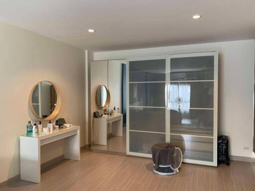 Spacious bedroom with dressing table and large closet