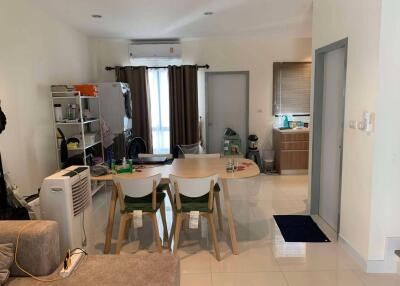 Living room with dining table and view of the kitchen