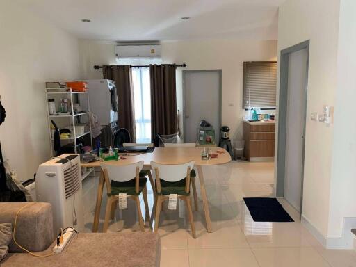 Living room with dining table and view of the kitchen