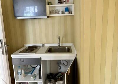 Compact kitchenette with open cabinets