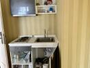 Compact kitchenette with open cabinets