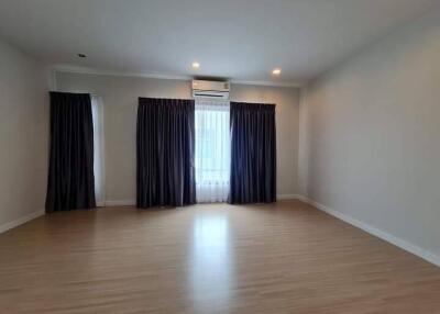 Spacious empty bedroom with wooden floor