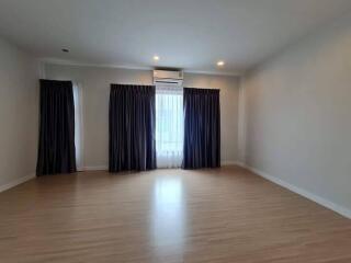 Spacious empty bedroom with wooden floor