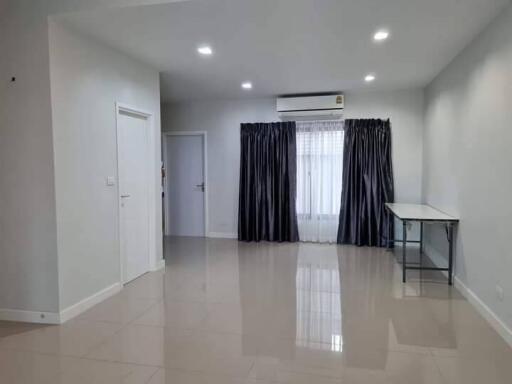 Spacious main living area with modern lighting and tiled flooring