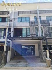 Three-story townhouse with a carport