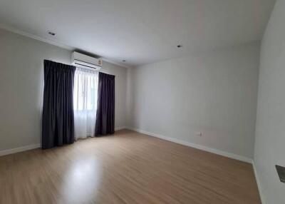 Spacious empty bedroom with window and dark curtains