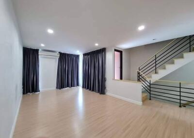 Spacious living room with modern staircase