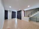 Spacious living room with modern staircase