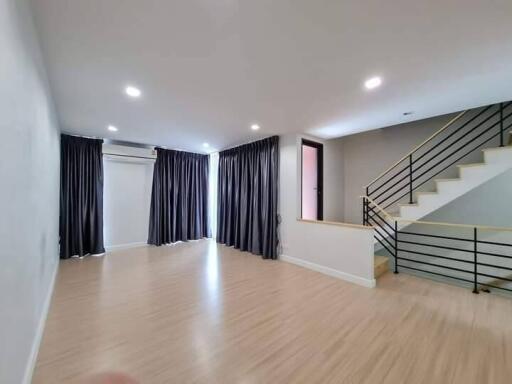 Spacious living room with modern staircase