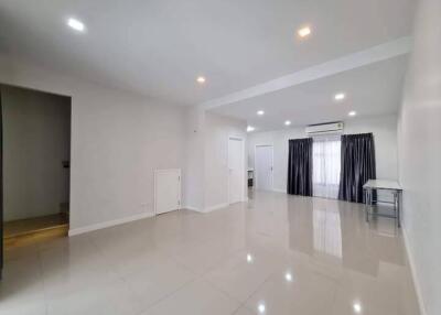 Spacious living room with modern lighting and large windows