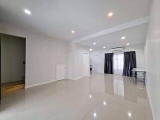 Spacious living room with modern lighting and large windows