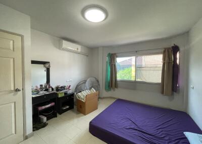 Simple bedroom with mattress, window, and vanity