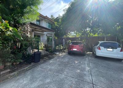 Front view of a house with driveway and parked cars