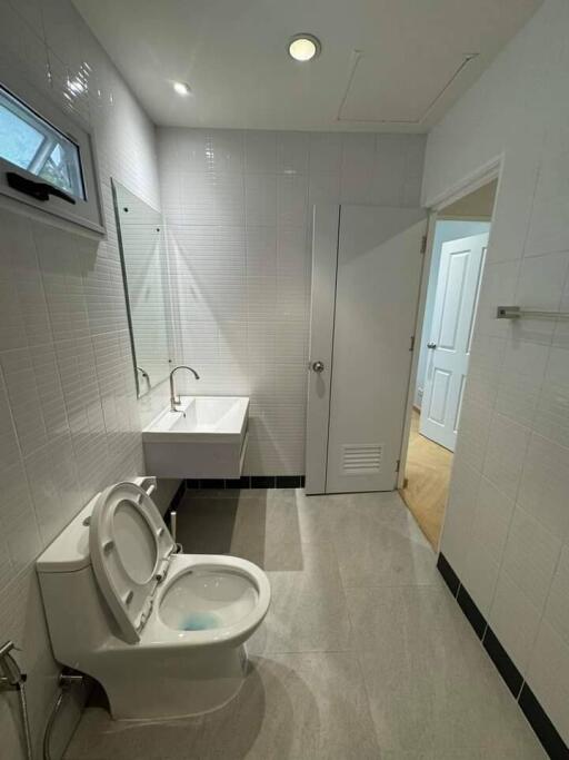 Modern bathroom with white tiles and fixtures