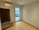 empty bedroom with wooden floor and natural light