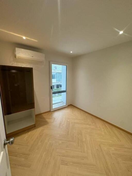 empty bedroom with wooden floor and natural light