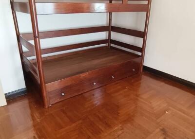 Bedroom with wooden bunk bed and polished wooden floor