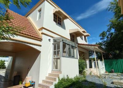 Exterior view of a residential house with a covered carport