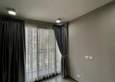 Bedroom with large window and curtains