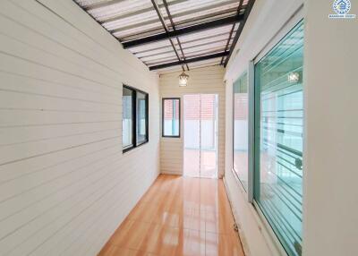 Bright hallway with large windows and tiled floor