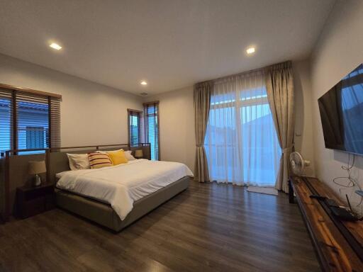 Spacious modern bedroom with various furnishings