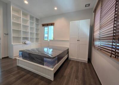 Modern bedroom with built-in shelving and large window