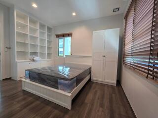 Modern bedroom with built-in shelving and large window