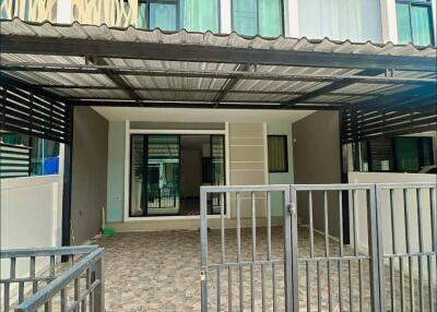 Modern two-story house exterior with gated driveway