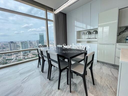 Modern dining area with large windows and city view