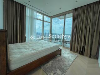 Spacious bedroom with large windows and balcony