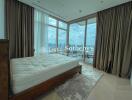 Spacious bedroom with large windows and balcony