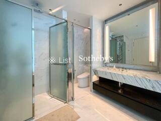 Modern bathroom with glass shower and marble sink