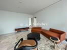 Modern living room with brown leather sofas and marble flooring